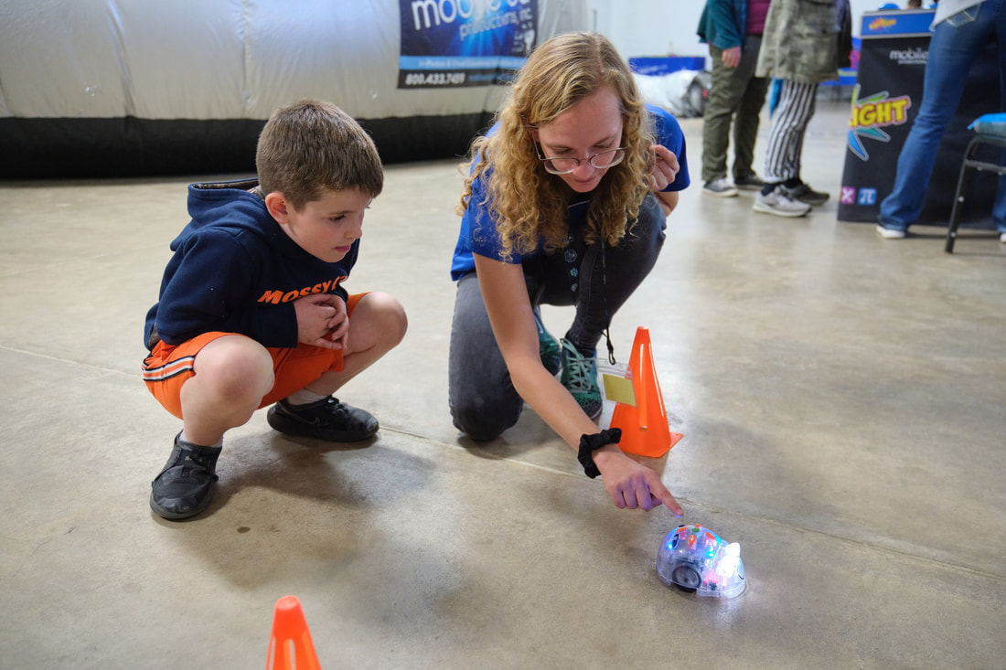 Families exploring a hands-on science activity at E3RC